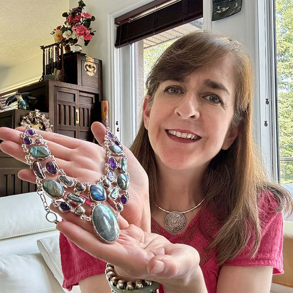 Woman showing Mexican silver necklace with gemstones