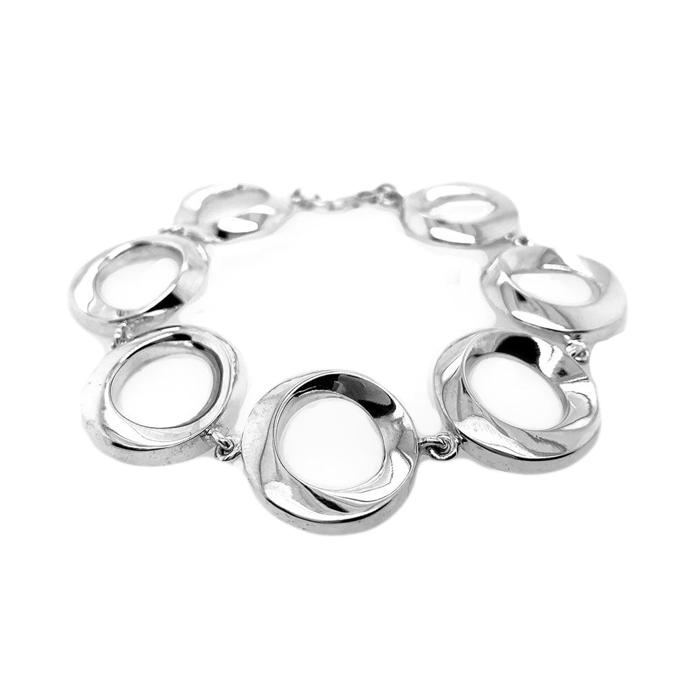 Handcrafted Taxco silver bracelet featuring articulated circular links in solid .925 sterling silver, reflecting a soft artisan polish.