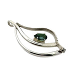 Contemporary 925 sterling silver artisan jewelry from Mexico with a fluid silhouette and natural peridot accent.
