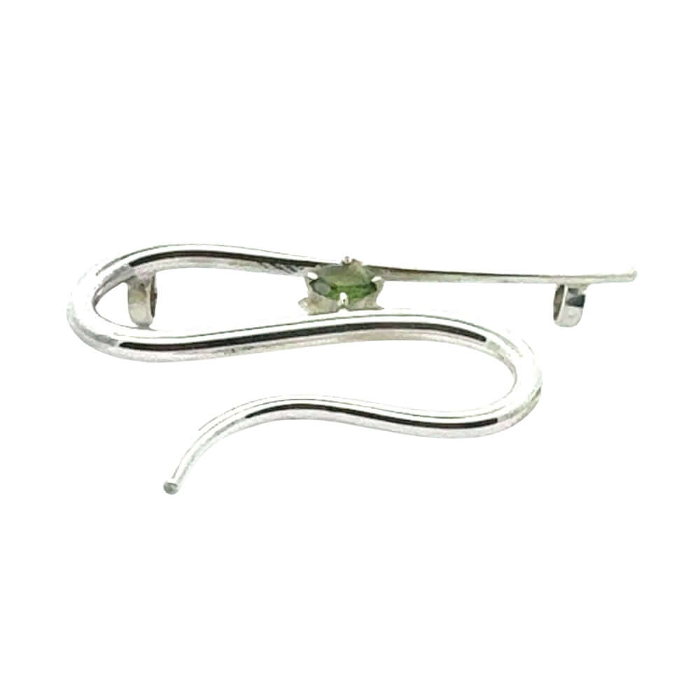 Side profile of an artisan silver pendant showing the depth and hand-forged construction of the openwork metal design.