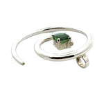 Side profile of a handmade silver pendant showing the integrated bail and high-polish finish.