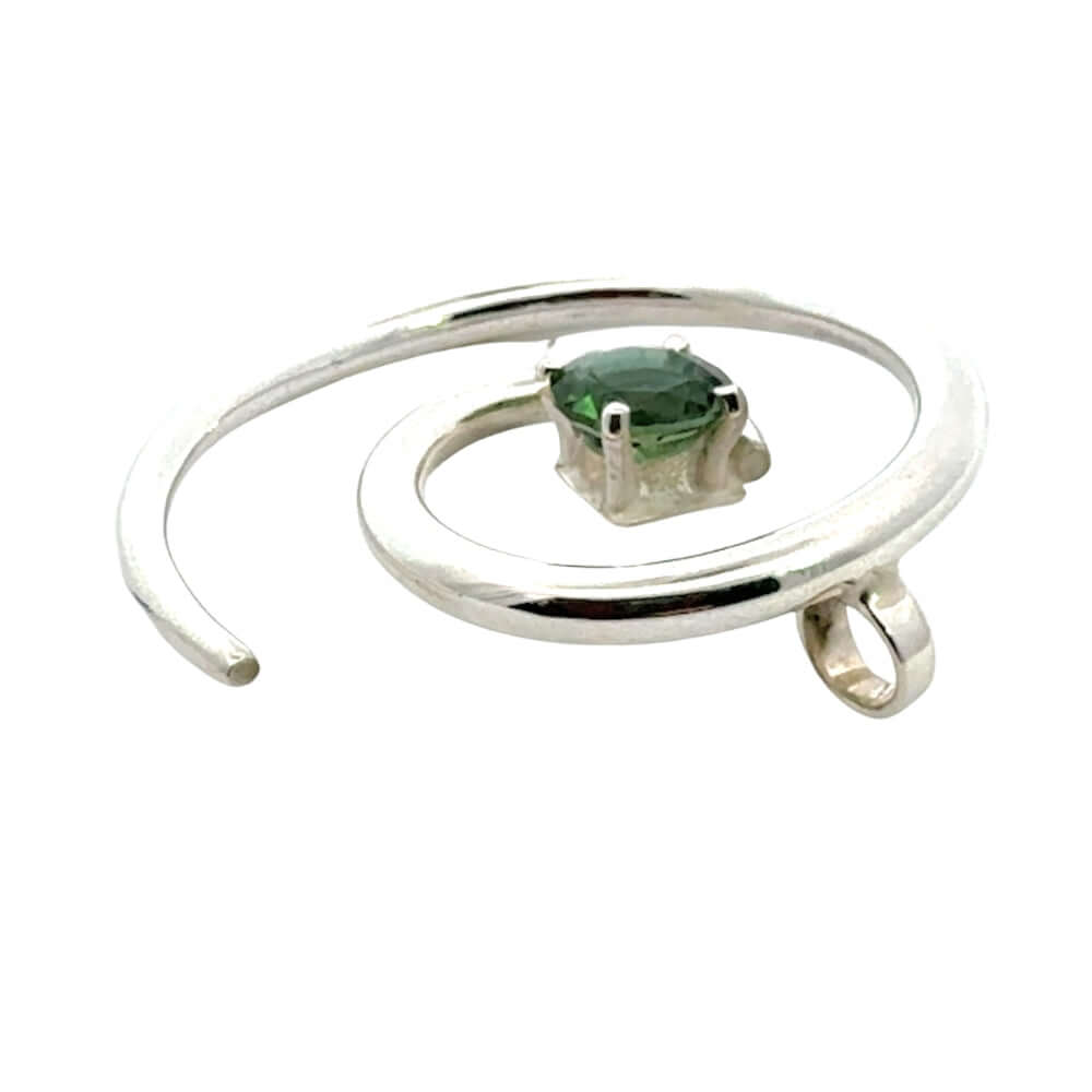 Side profile of a handmade silver pendant showing the integrated bail and high-polish finish.