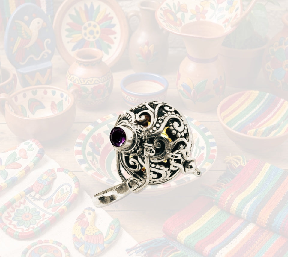 Taxco silver pendant with amethyst on a colorful, patterned background