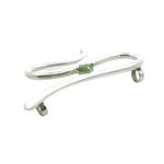 Angled view of a handmade silver jewelry piece highlighting the polished finish and secure gemstone setting.