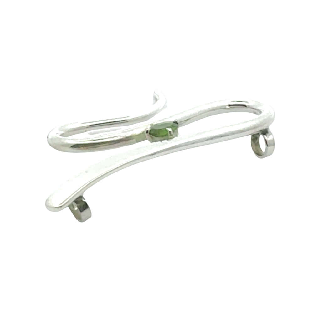 Angled view of a handmade silver jewelry piece highlighting the polished finish and secure gemstone setting.