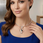 Lifestyle view of a woman wearing an elegant Taxco artisan silver pendant on a silver choker, showcasing its bold yet graceful scale.