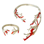 950 Silver and red coral branch-like jewelry piece on a white background