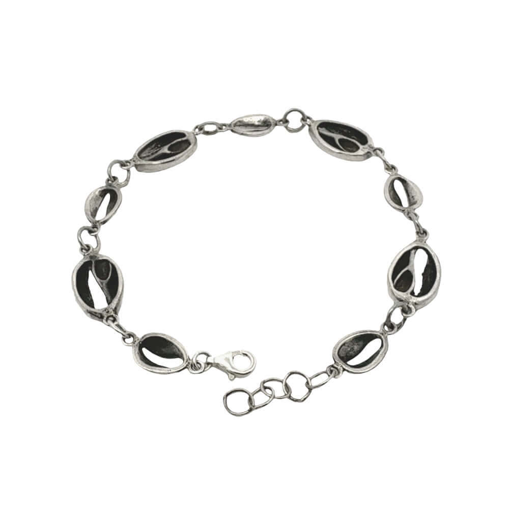 Silver bracelet with black oval stones on a white background