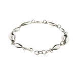 Silver bracelet with shell-like links on a white background
