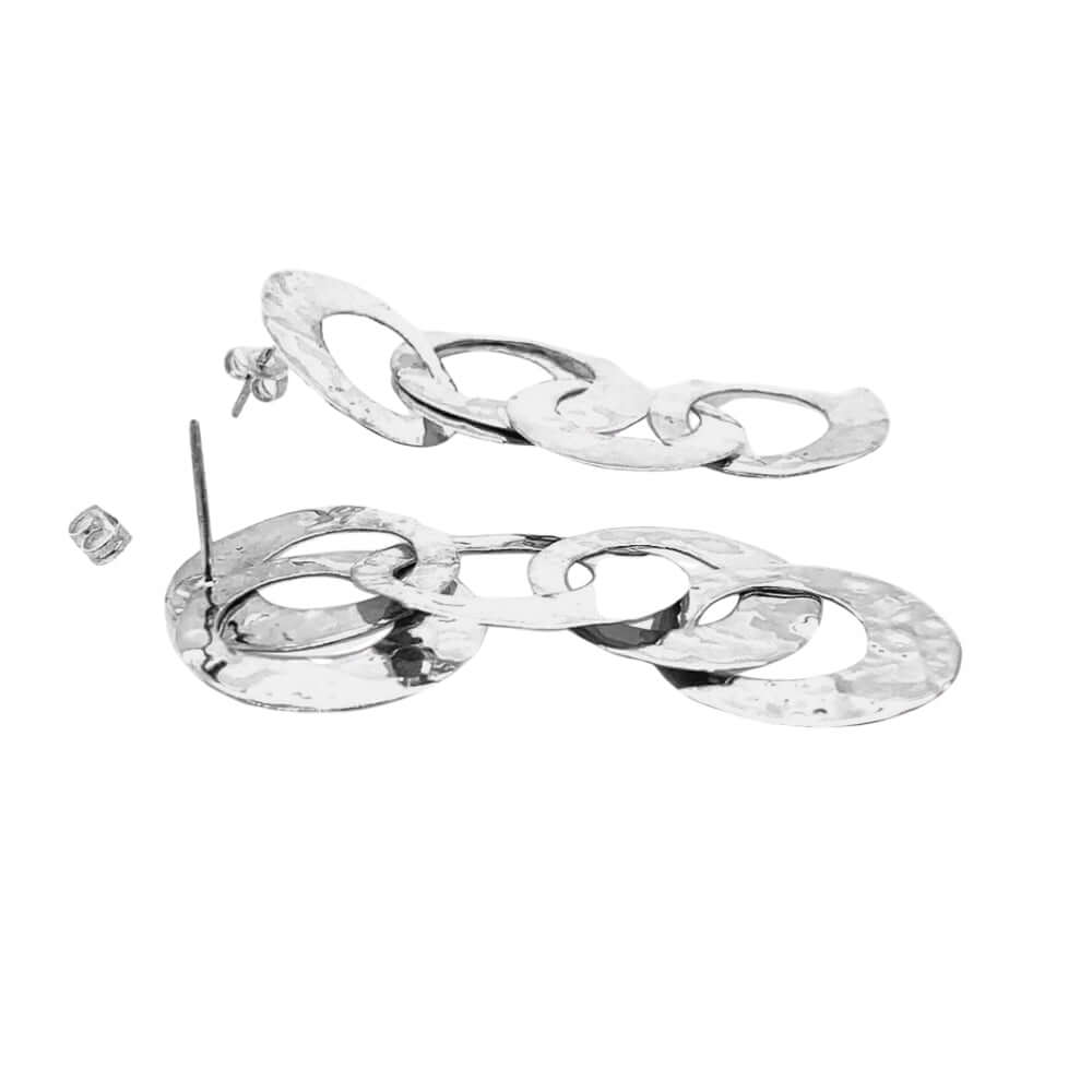 Pair of silver earrings with interlocking loops on a white background