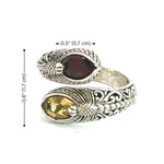 Silver ring with gemstones and measurements on a white background
