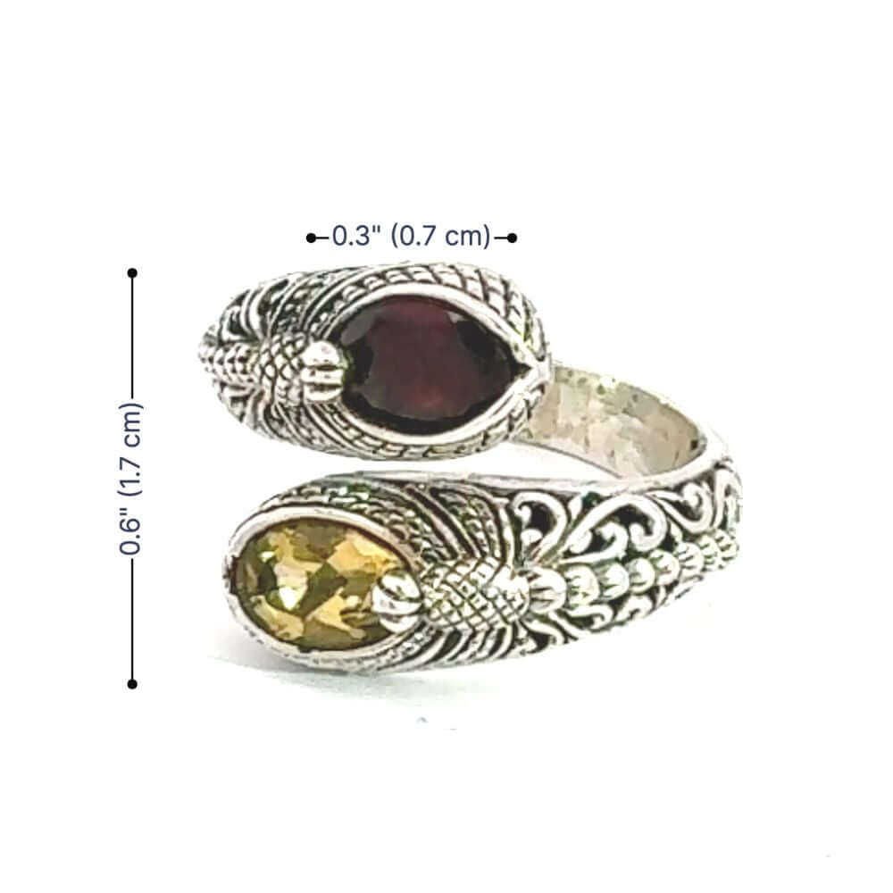 Silver ring with gemstones and measurements on a white background