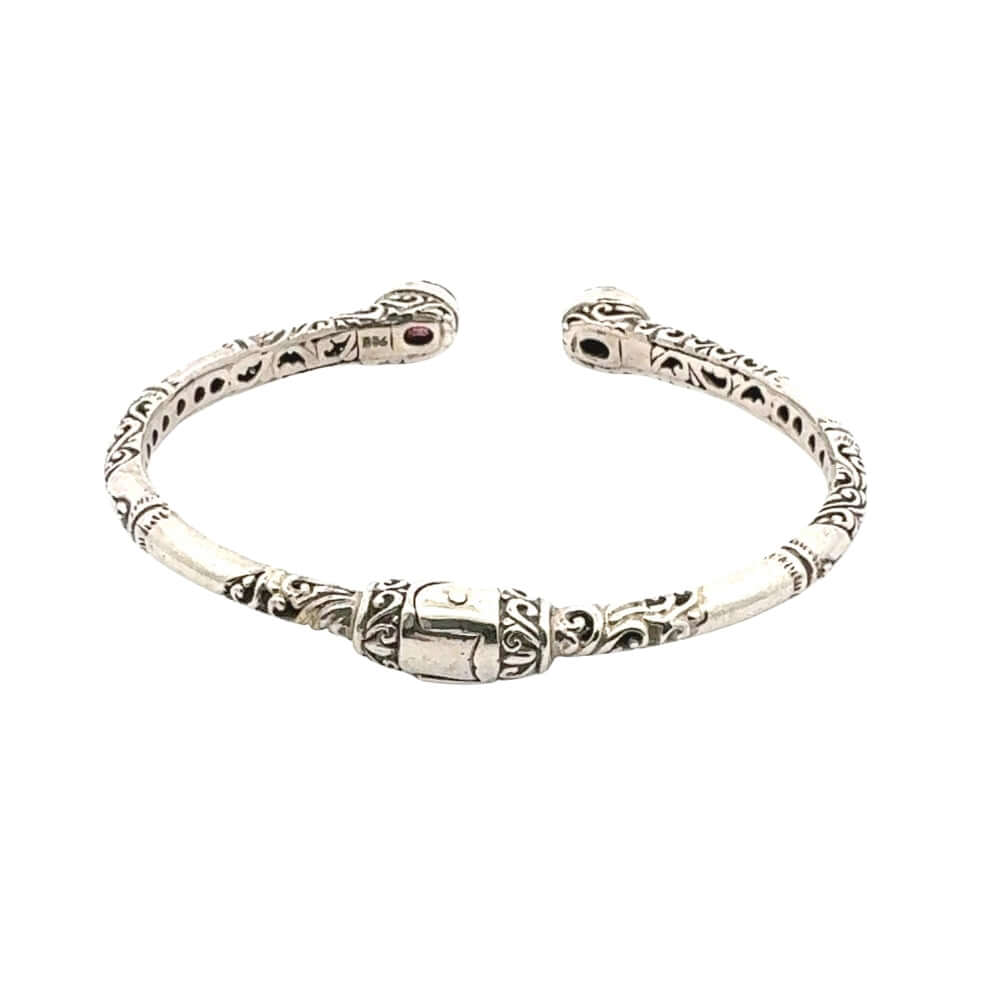 Silver bracelet with intricate designs on a white background