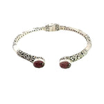 Silver bracelet with carved amethyst on a white background