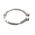 Silver bracelet with intricate designs on a white background