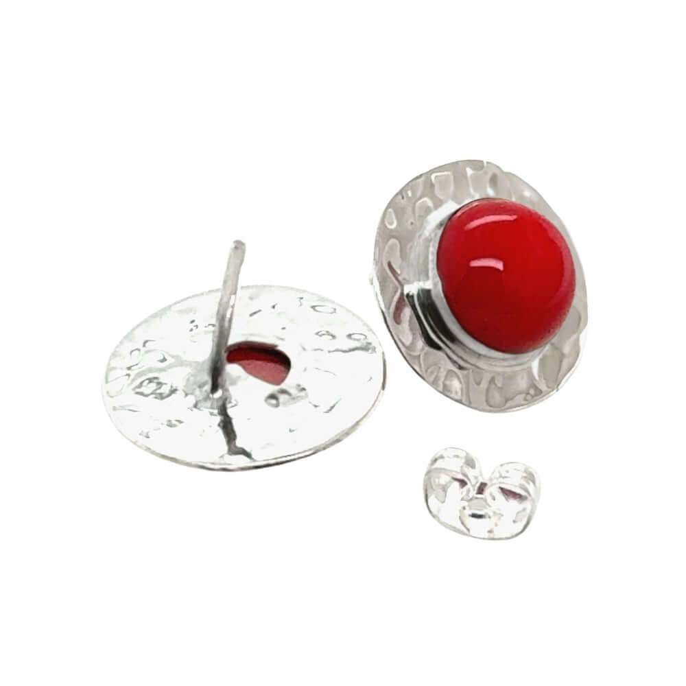 Silver earring with red coral on a white background