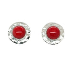 Pair of round earrings with red coral and silver rims on a white background