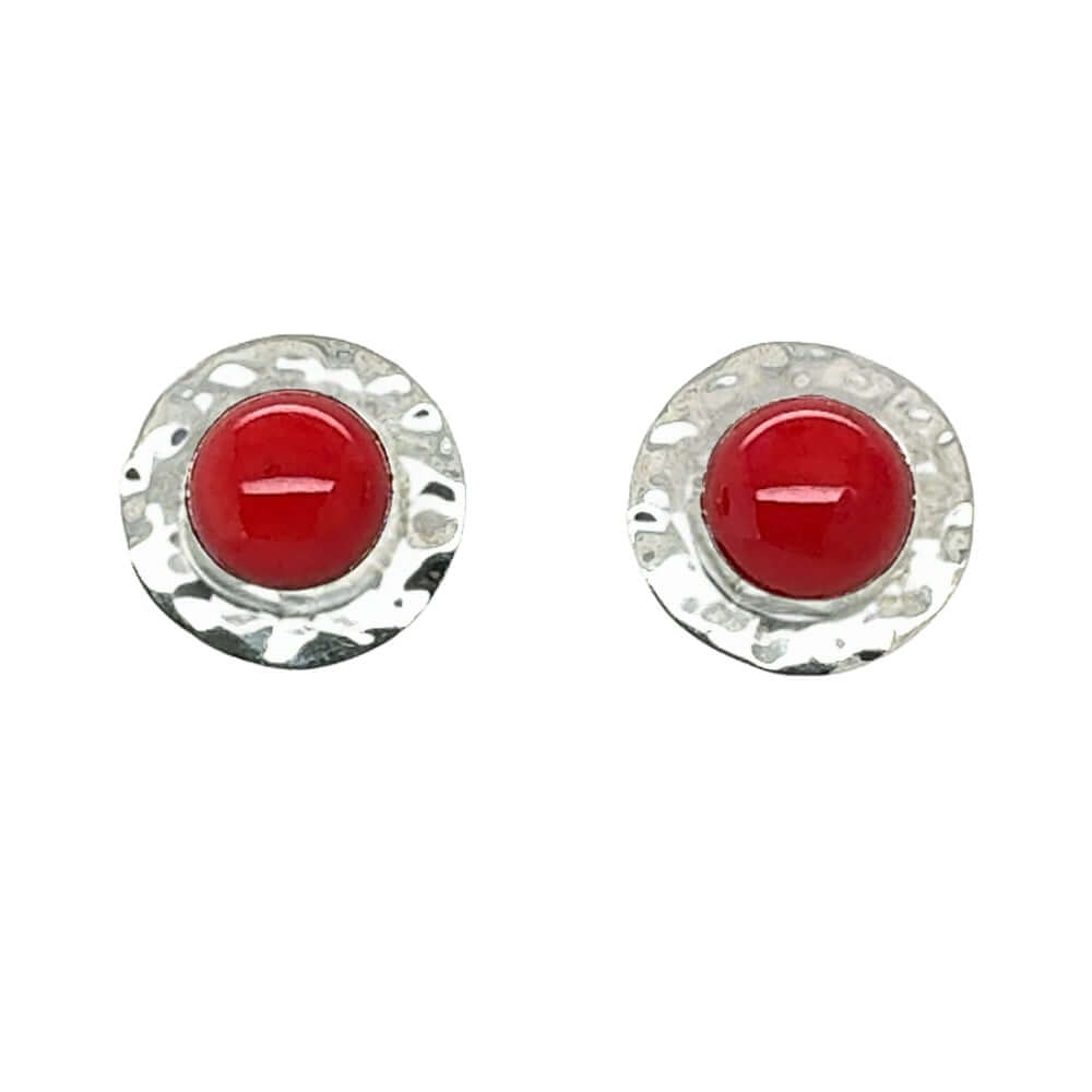 Pair of round earrings with red coral and silver rims on a white background