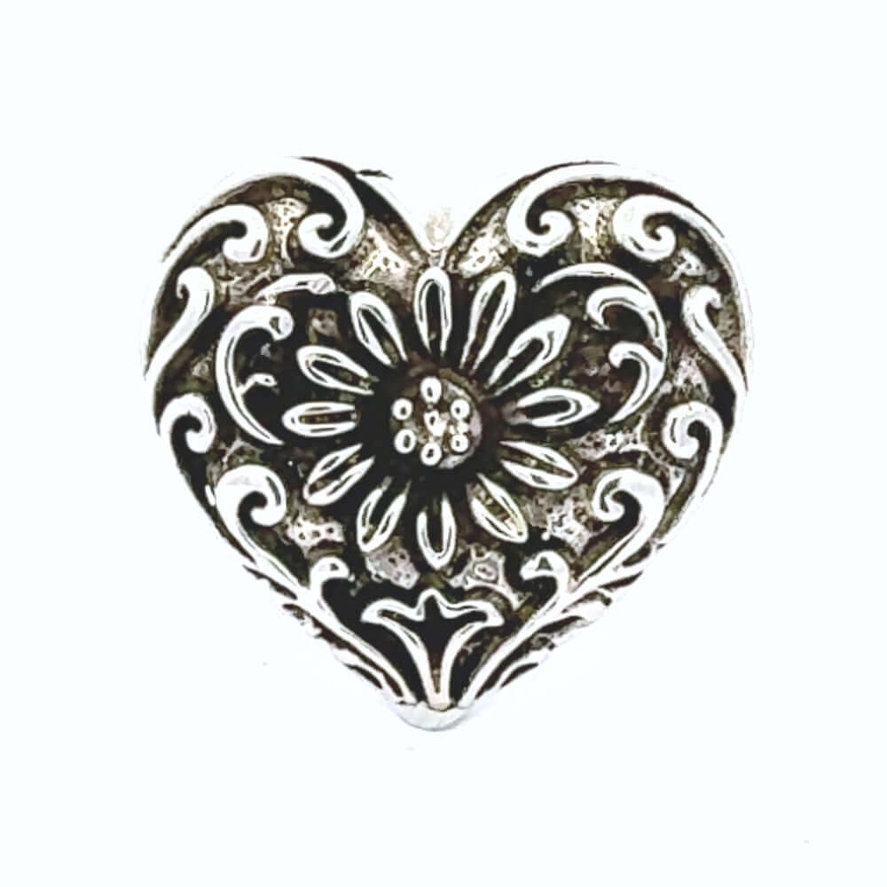 Taxco heart-shaped silver ring with intricate patterns on a white background