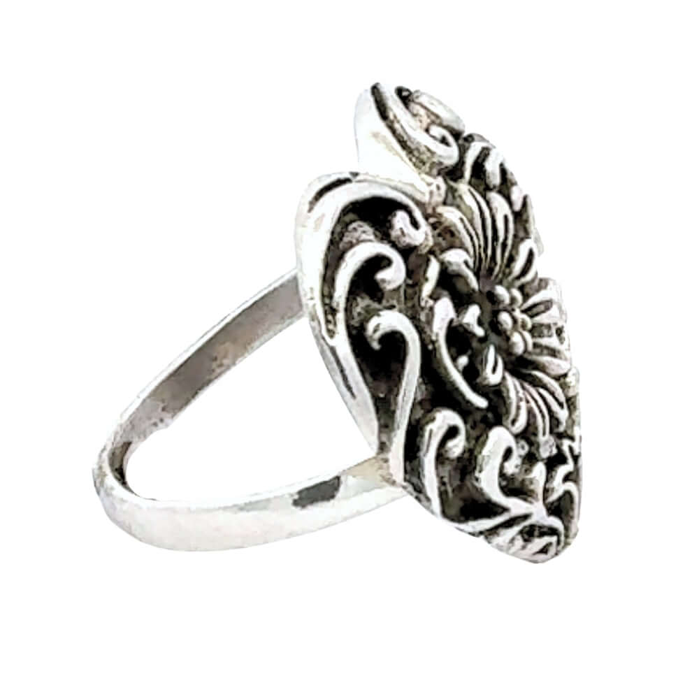 Silver ring with intricate design on a white background