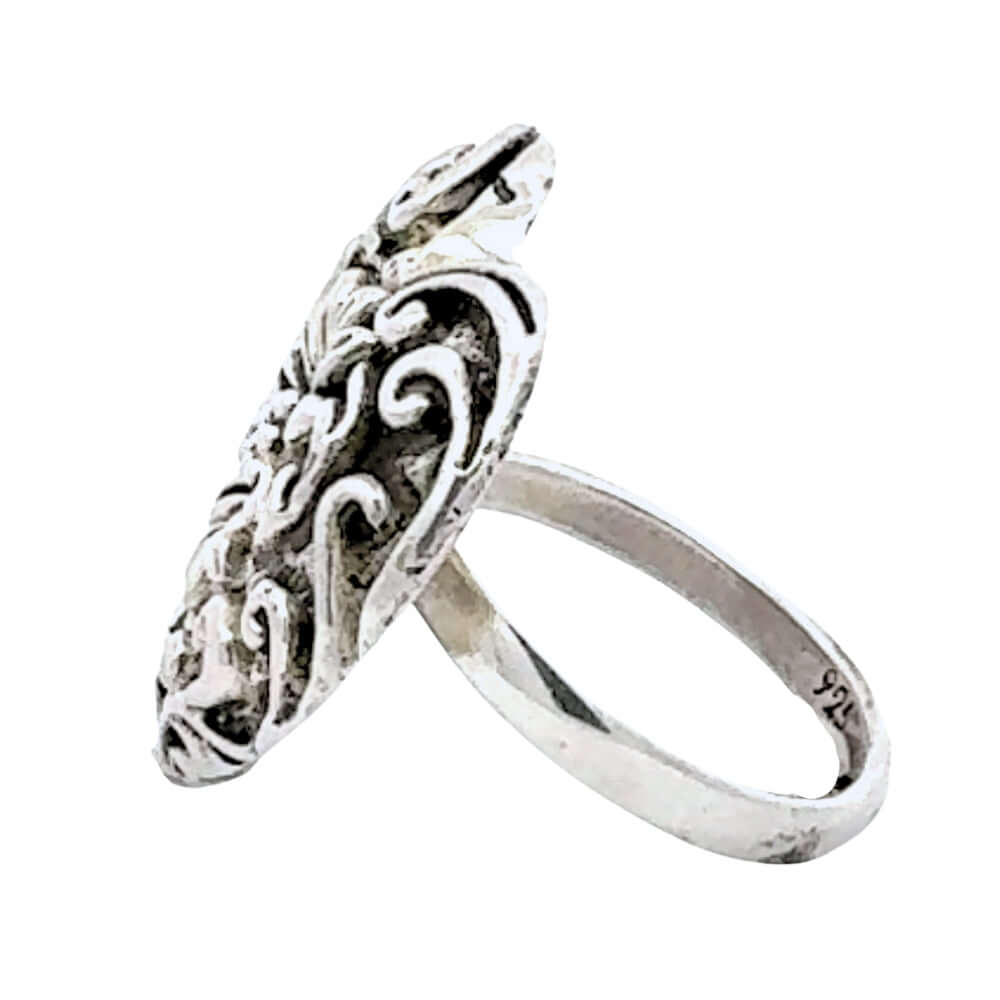 Silver ring with intricate design on a white background