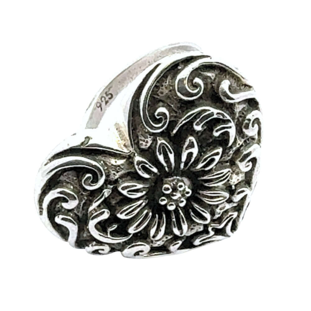 Silver heart-shaped pendant with floral design on a white background showing 925 stamp