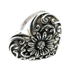 Silver heart-shaped pendant with floral design on a white background showing 925 stamp
