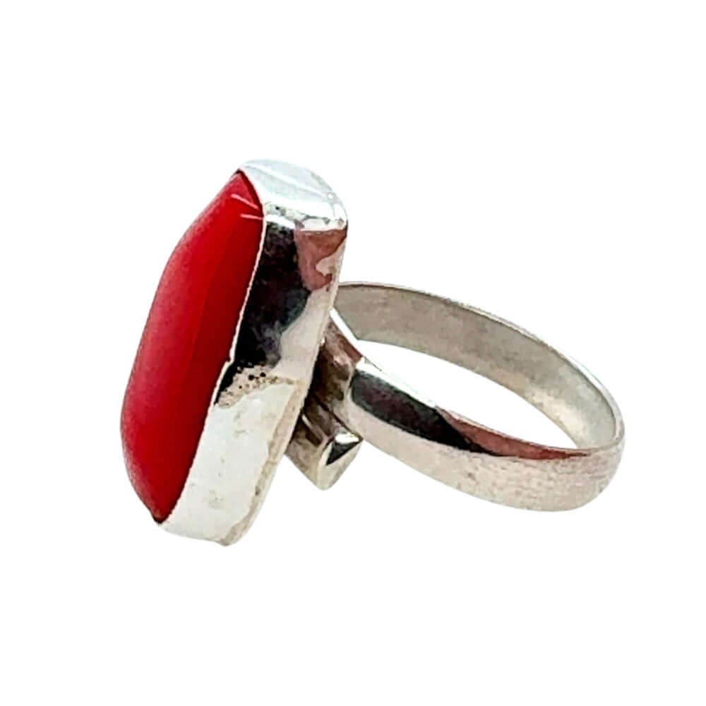 Silver ring with a red doral on a white background