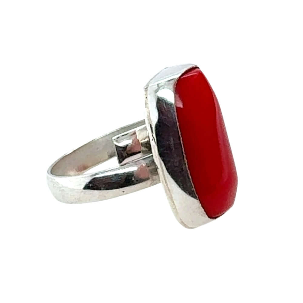 Silver ring with a red coral on a white background