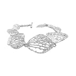 Silver bracelet with intricate design on a white background