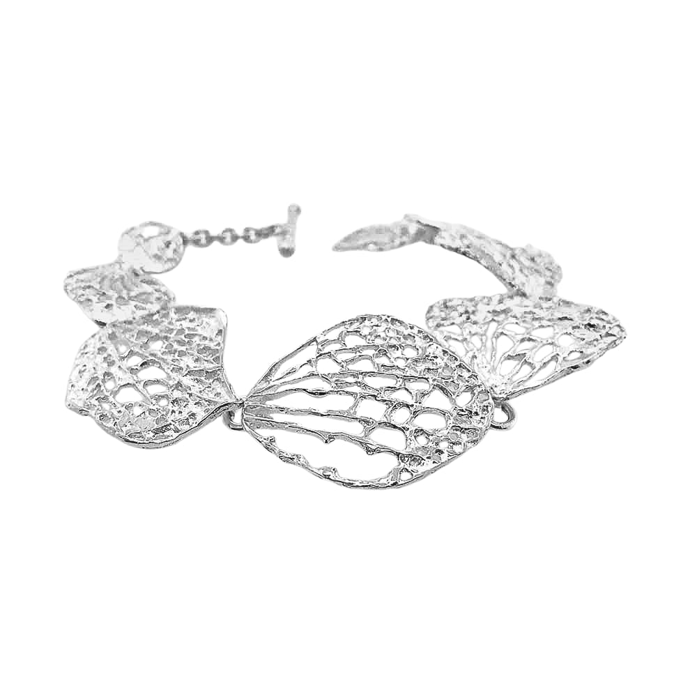 Silver bracelet with intricate design on a white background