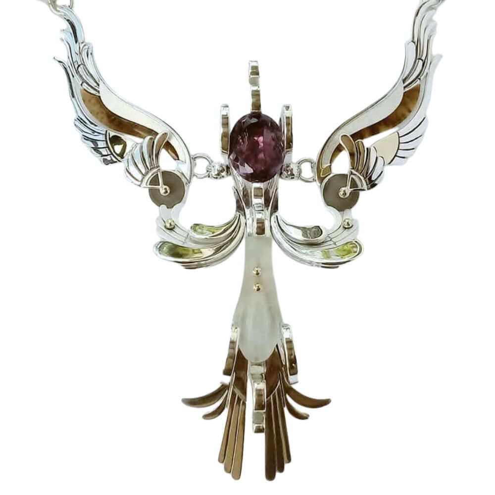 Ornate necklace with a central purple gemstone on a white background