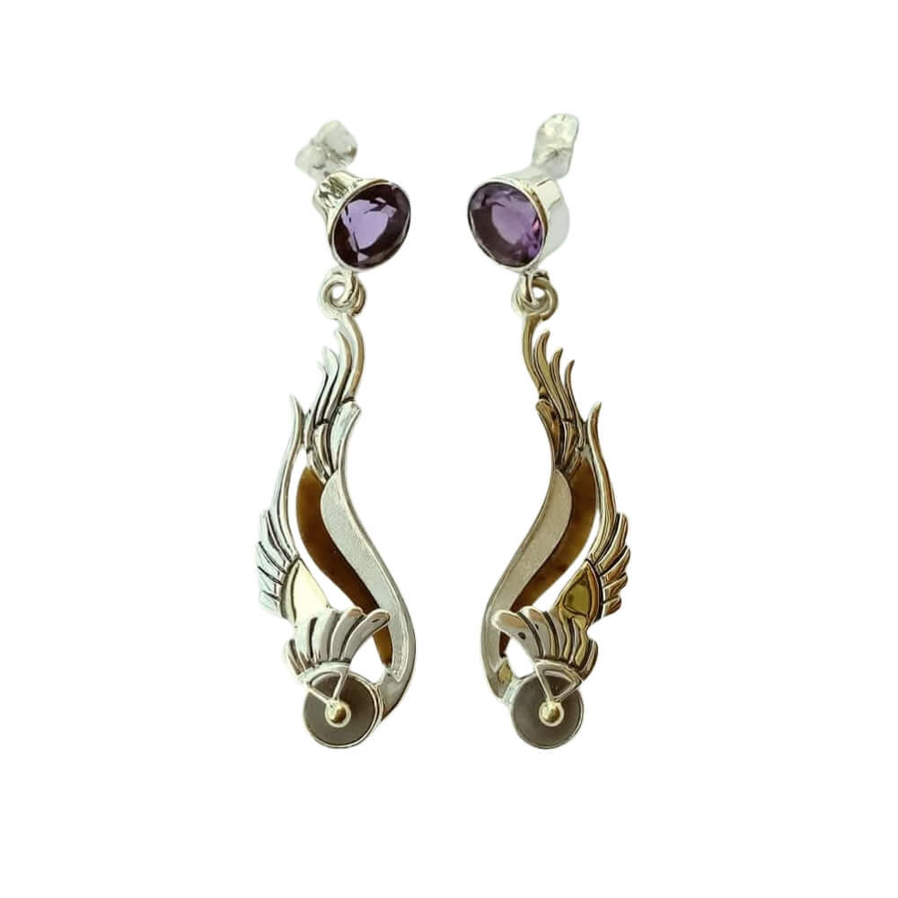 Pair of earrings with wing-like design and purple gemstones on a white background