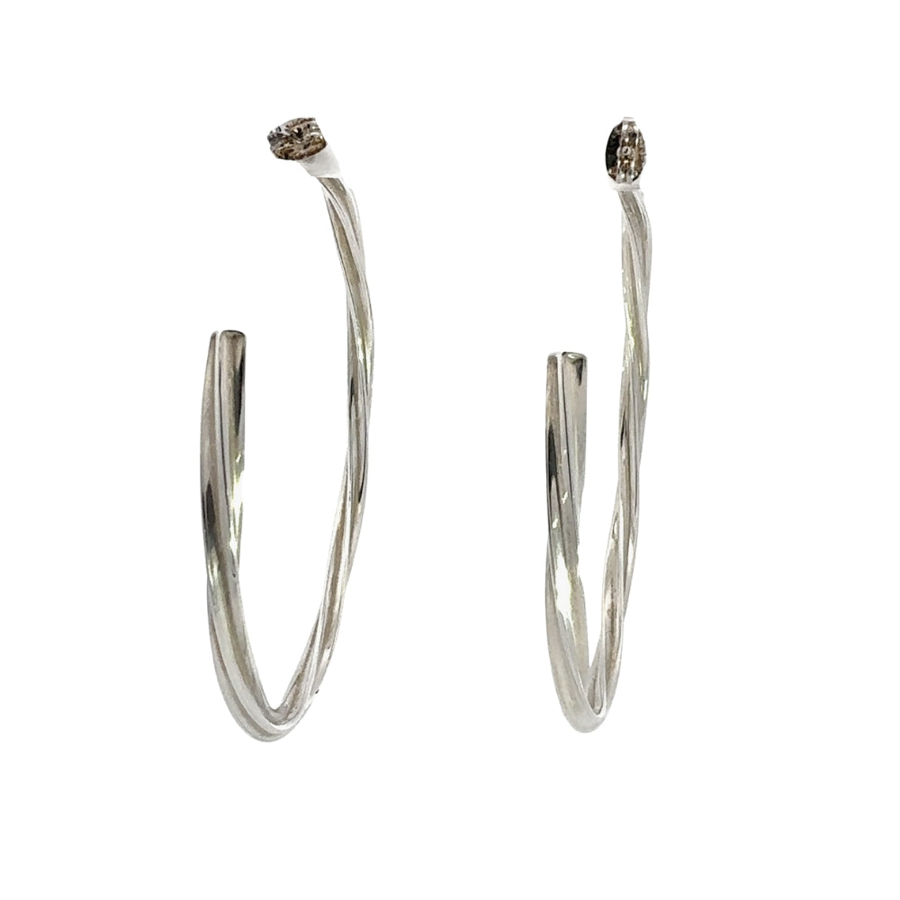 Pair of silver hoop earrings on a white background