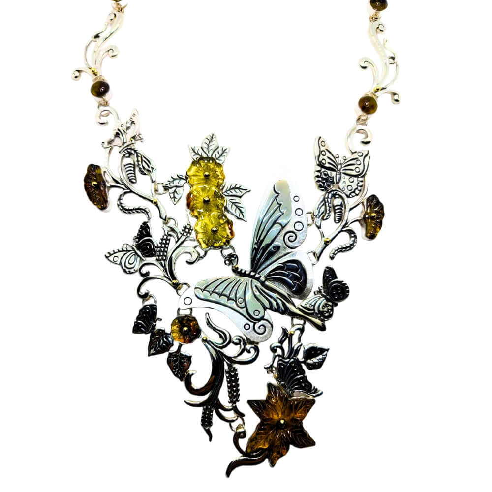 Ornate necklace with butterfly and floral design on a white background