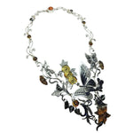 Ornate necklace with butterfly and leaf designs on a white background