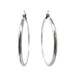 Pair of 8 cm silver hoop earrings on a white background