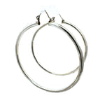 Pair of 8 cm silver hoop earrings on a white background