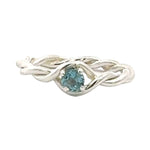 Silver ring with a blue gemstone on a white background