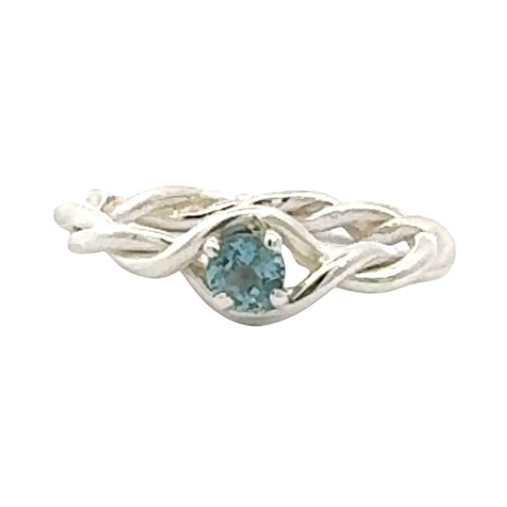 Silver ring with a blue gemstone on a white background