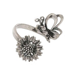 Silver ring with butterfly and sunflower design on a white background