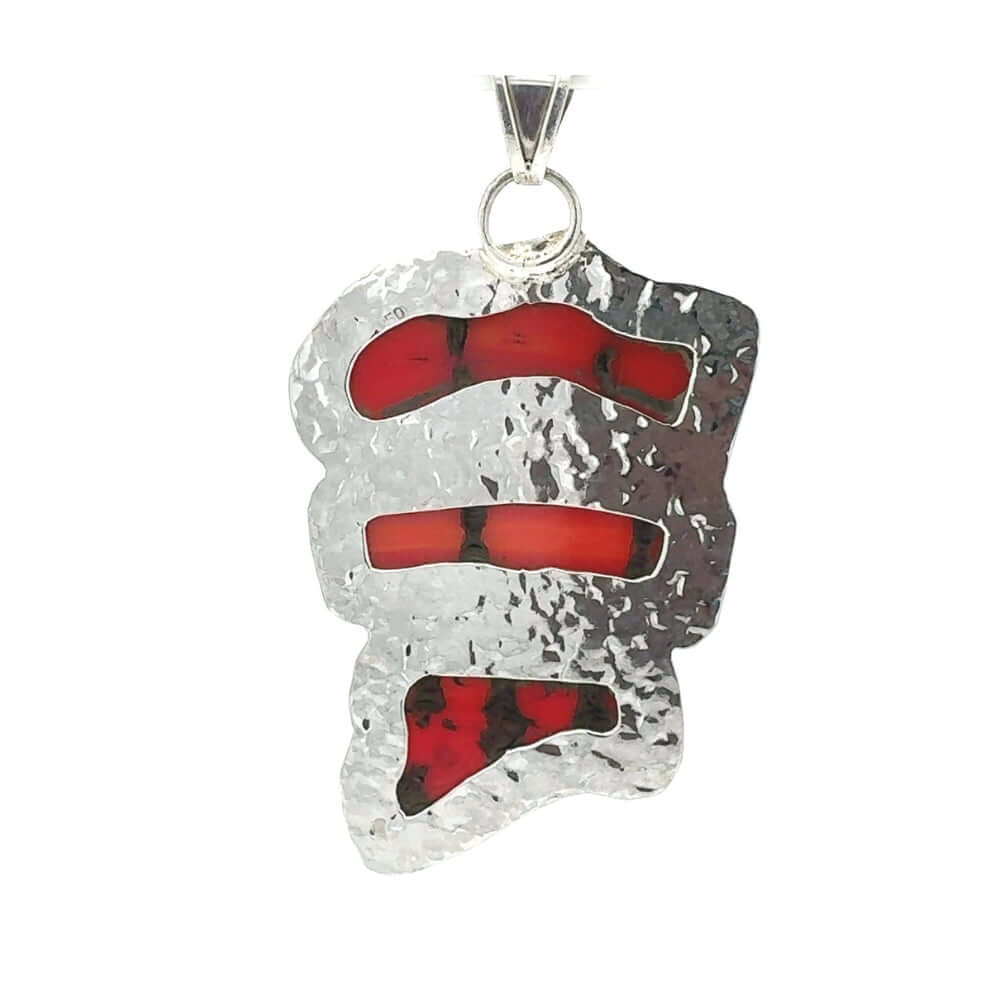 Back of silver pendant with red coral on a white background
