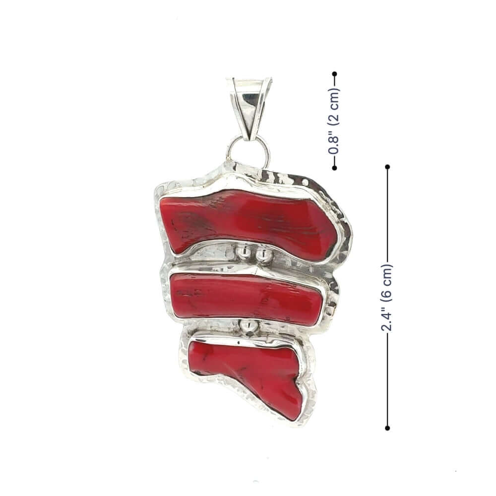 Red coral pendant with silver frame and measurements on a white background