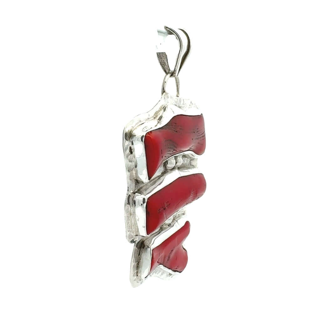 Silver pendant with red coral on a white background