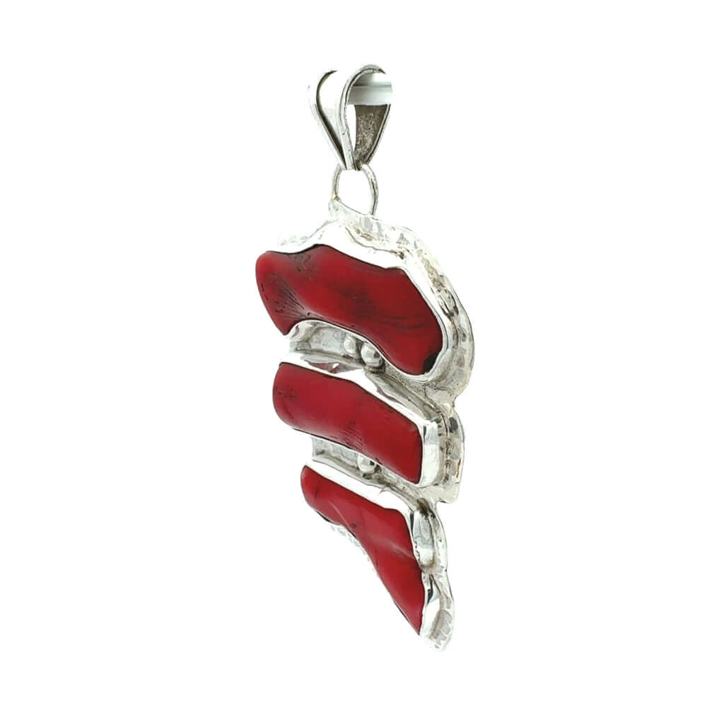 Red coral pendant with silver design on a white background