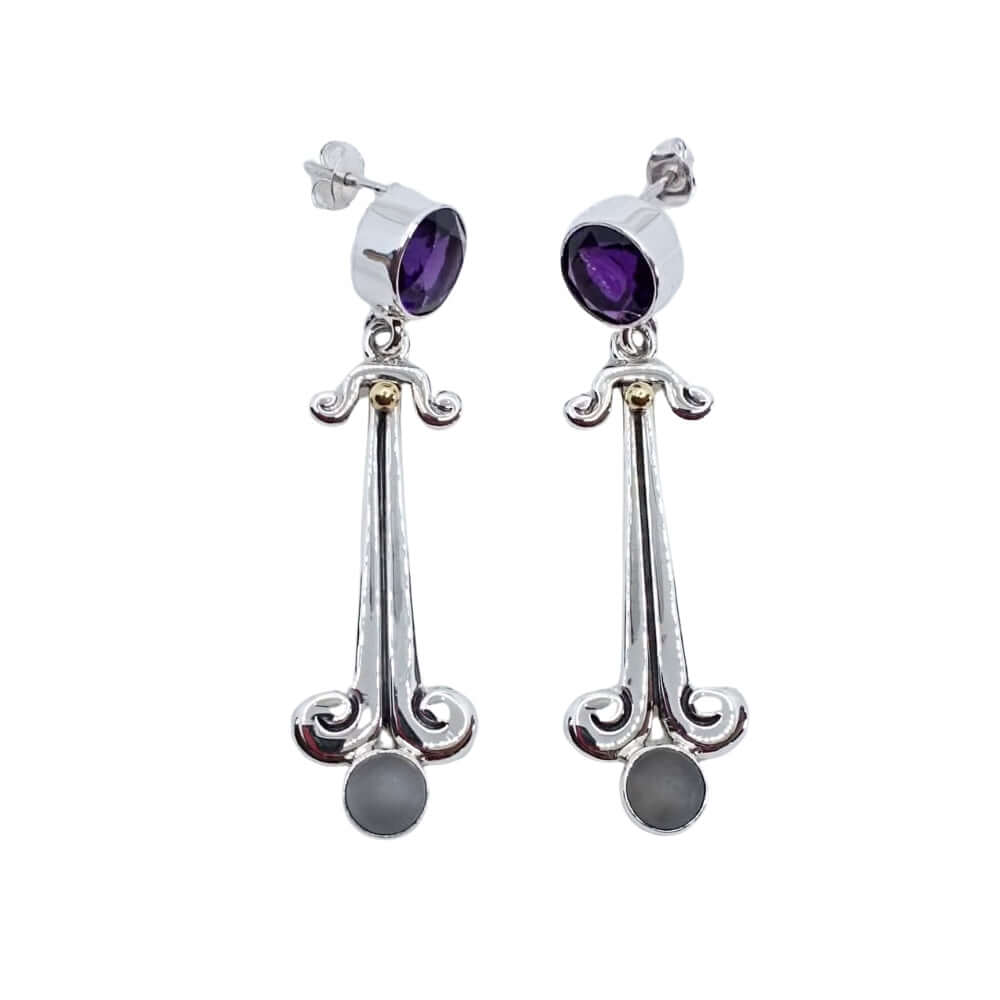 Silver earrings with purple and gray stones on a white background