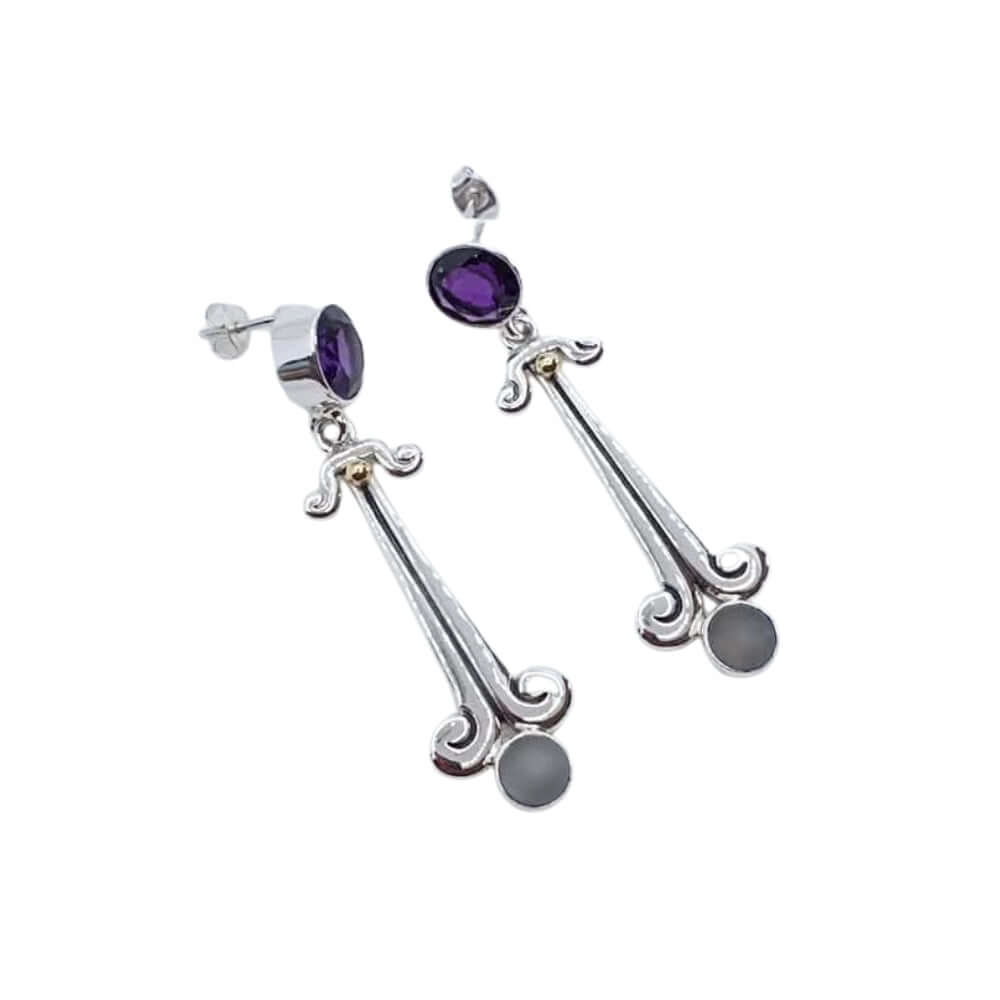 Silver earrings with amethyst and gray stones on a white background