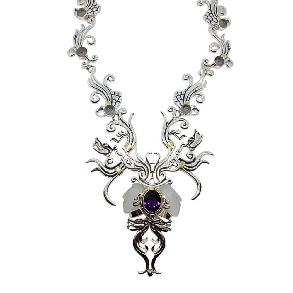 Ornate necklace with a central amethyst gemstone on a white background