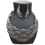 950 Silver bib-necklace and earrings with turquoise stones on a black mannequin bust.
