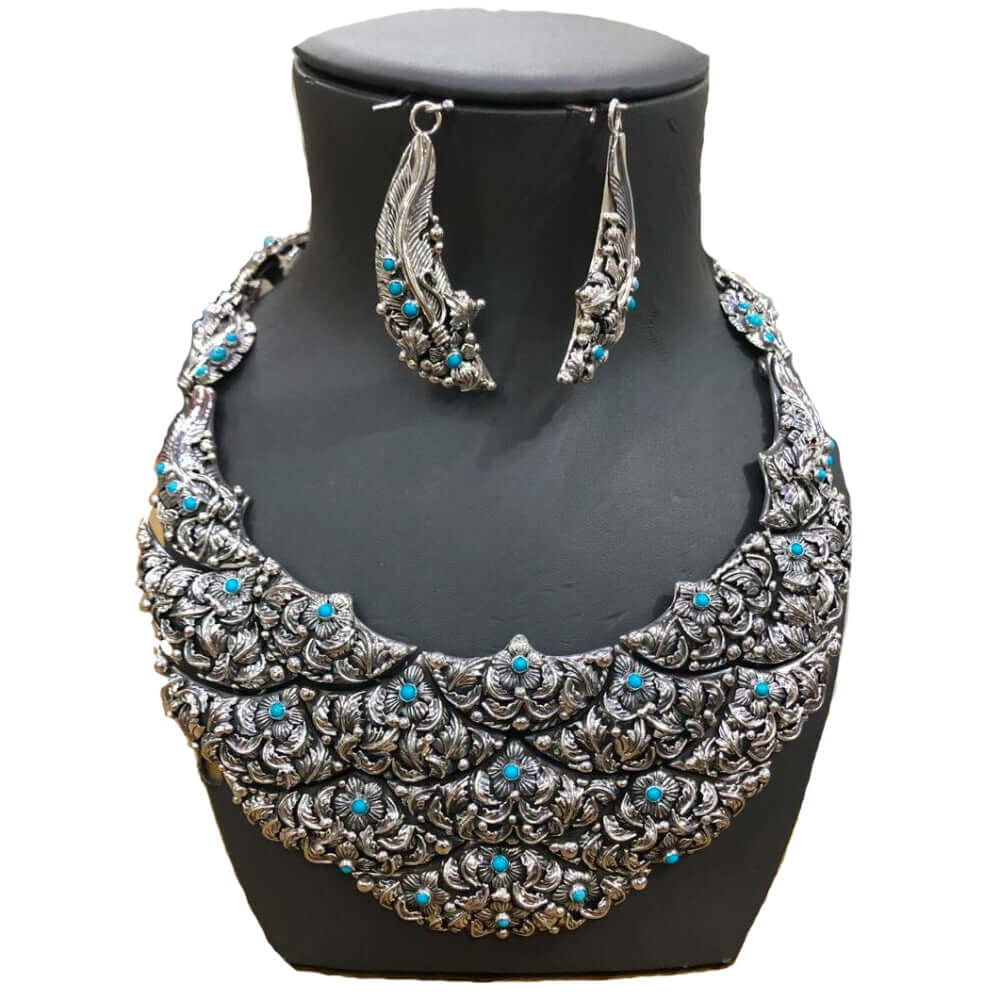 950 Silver bib-necklace and earrings with turquoise stones on a black mannequin bust.